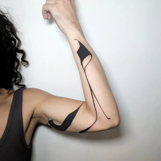 blackwork abstract tattoo on woman arm