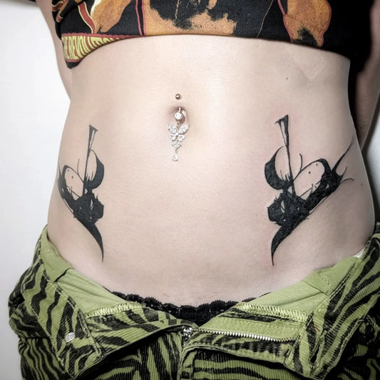 blackwork black ink brush stroke tattoo on woman stomach