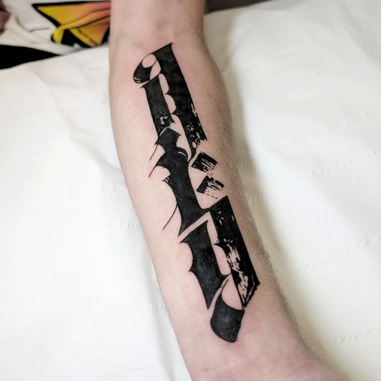blackwork bold letters on man inner arm