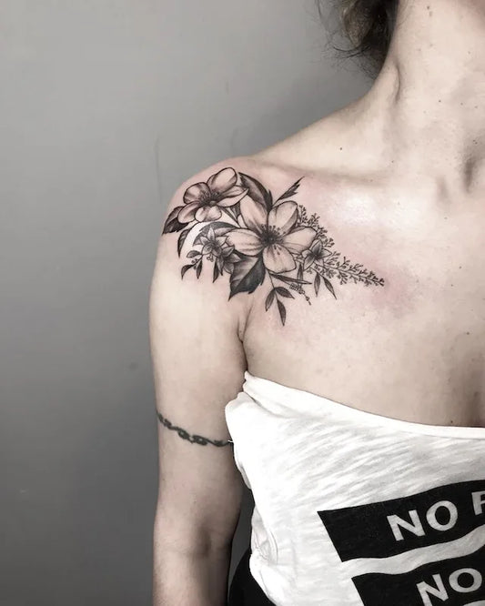 black and grey floral tattoo on woman shoulder