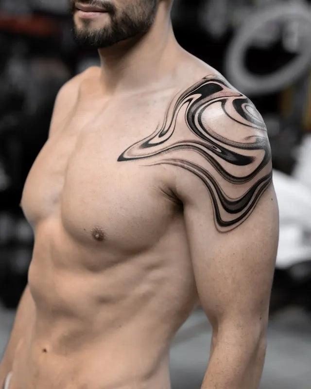 abstract blackwork marble tattoo on man shoulder