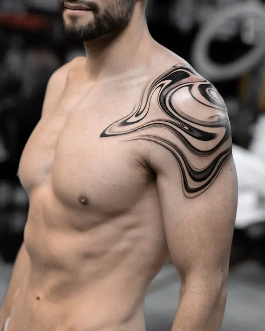 abstract blackwork marble tattoo on man shoulder