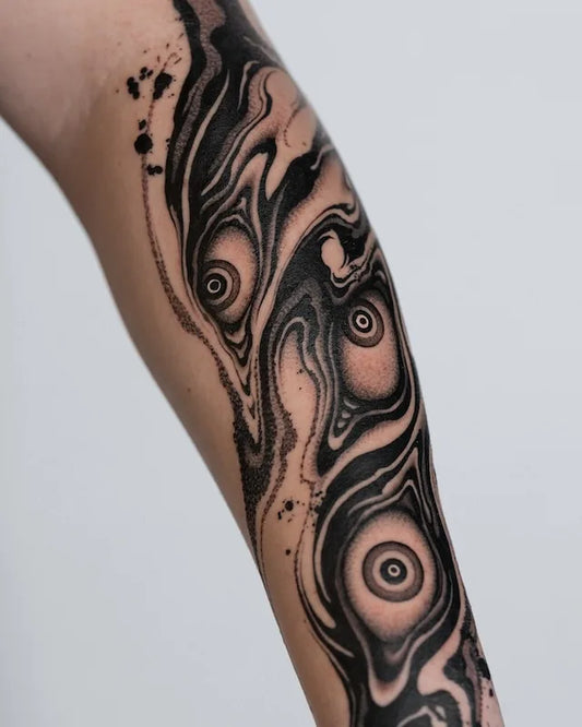 abstract blackwork creepy marble eyes tattoo on forearm