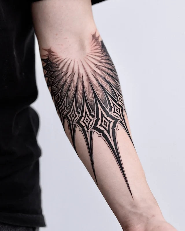 blackwork tribal pattern tattoo on forearm