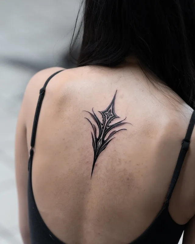 elegant blackwork tribal ornament cross tattoo on woman back