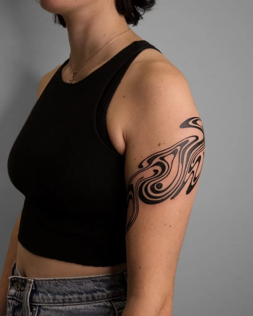 abstract blackwork pattern woman upper arm tattoo