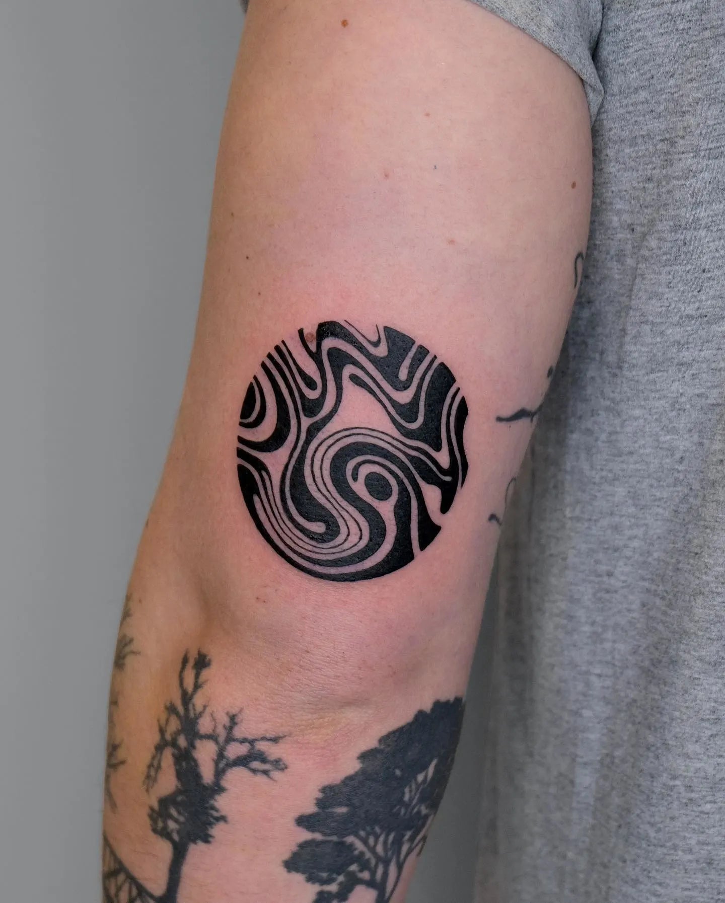 circle blackwork abstract pattern arm tattoo