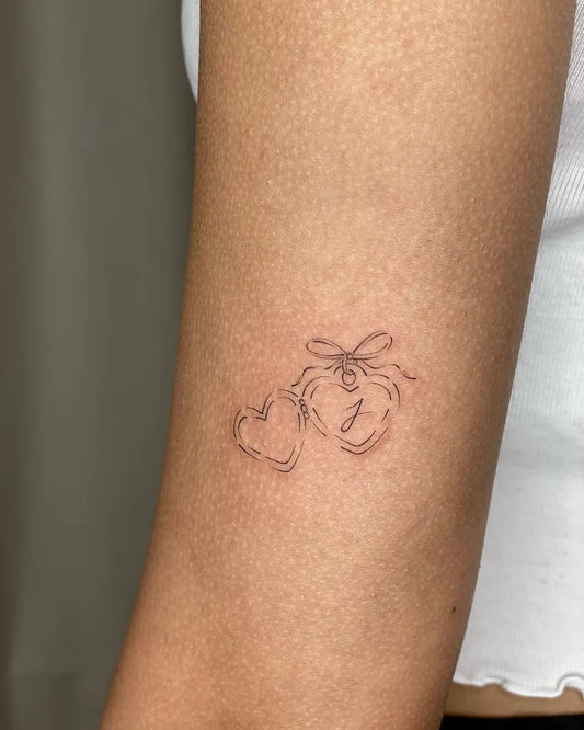 minimalist hearts outline arm tattoo