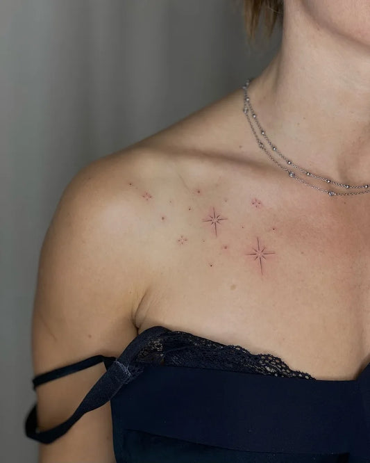 minimalist stars woman shoulder tattoo