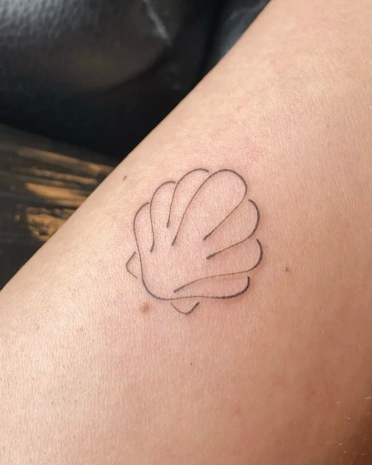 minimalist shell outline tattoo