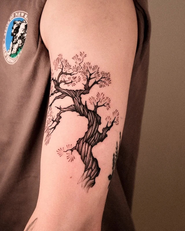 tree tattoo on man upper arm