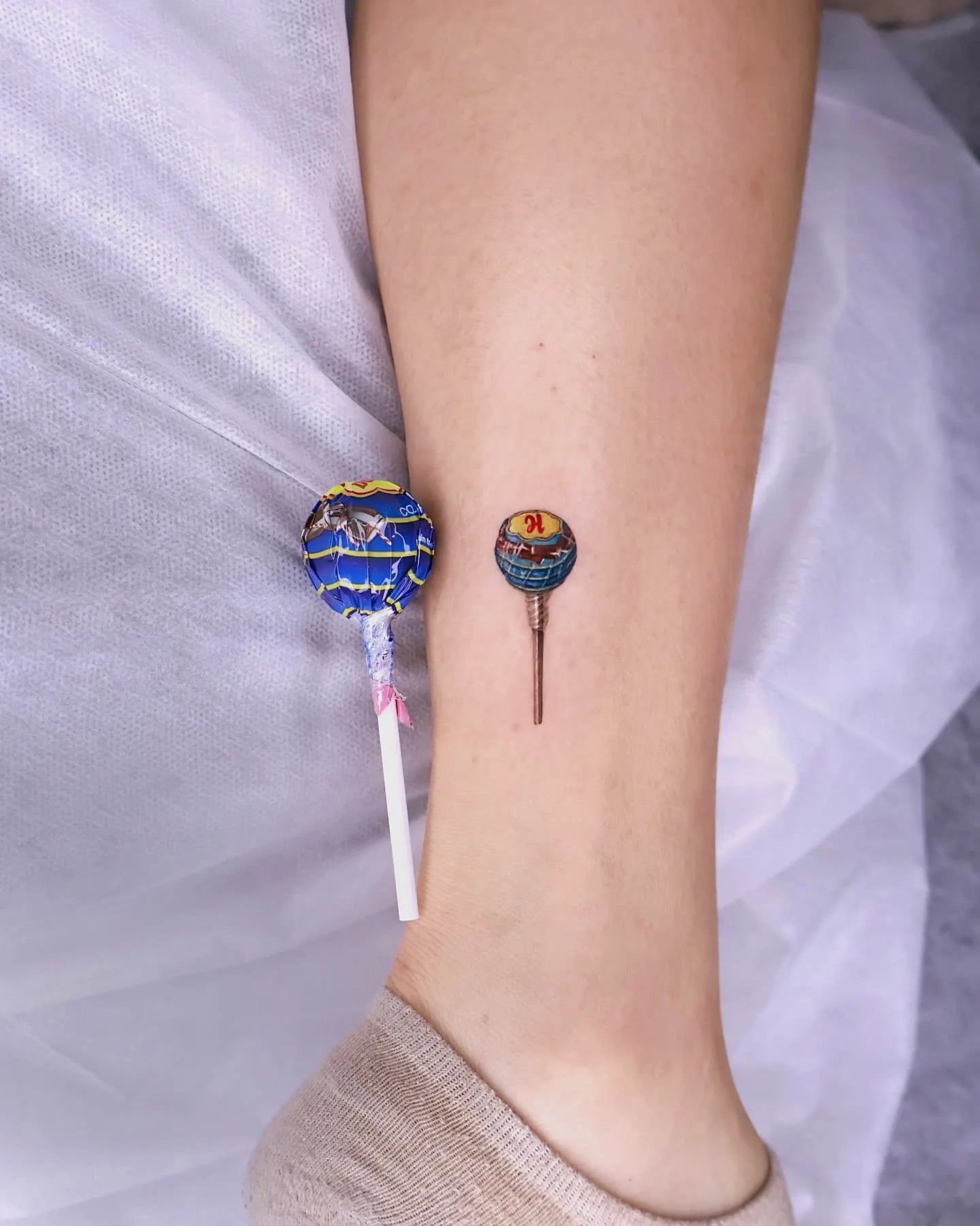 realistic Chupa Chups candy tattoo