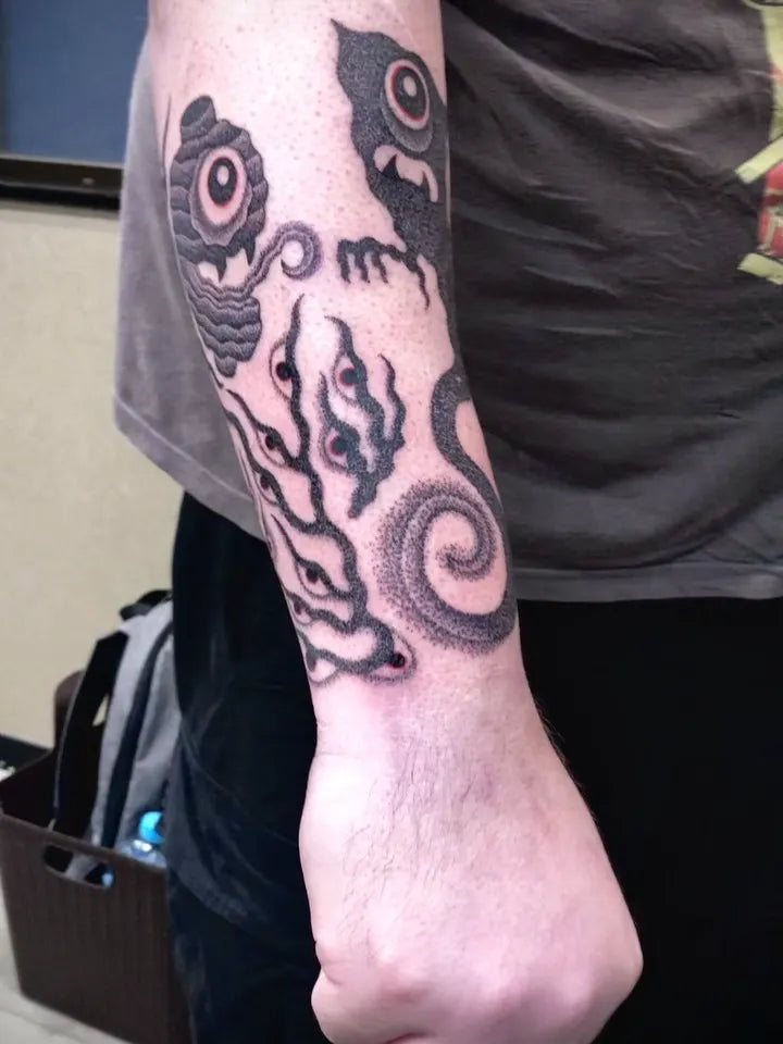 japanese one eye ghosts dotwork tattoo on man forearm