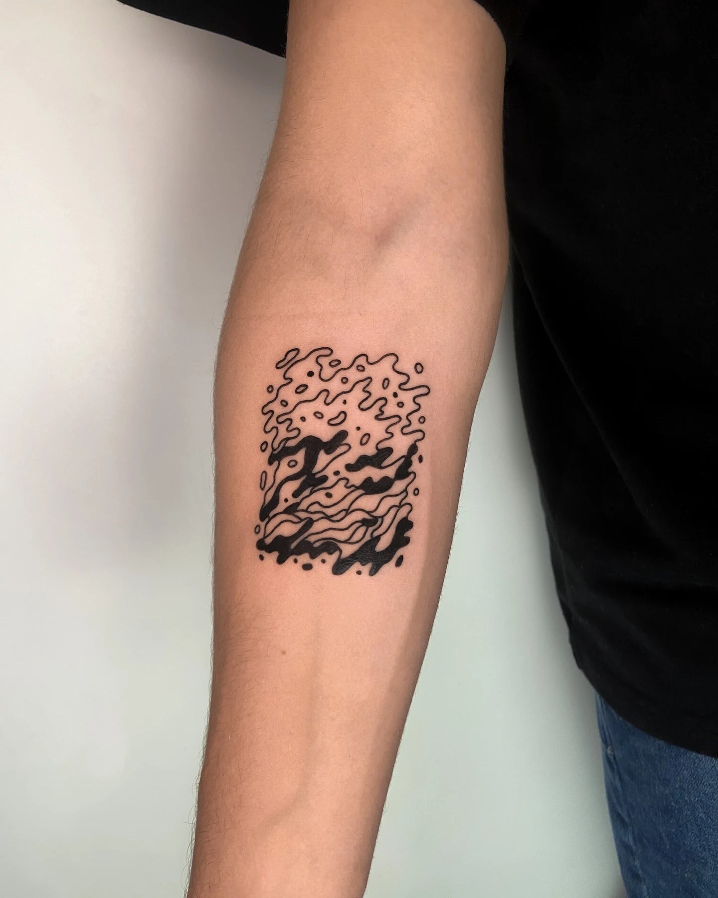 abstract blackwork outline pattern forearm tattoo