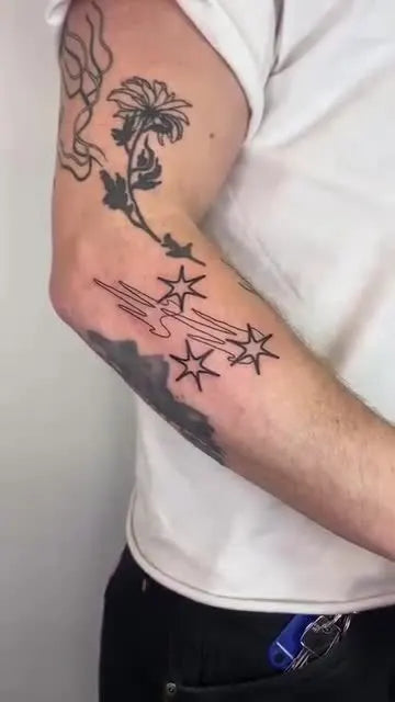 abstract stars outline forearm tattoo
