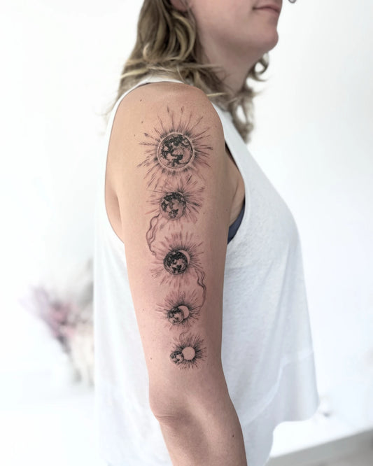 Solar Eclipse sun moon phase upper arm tattoo