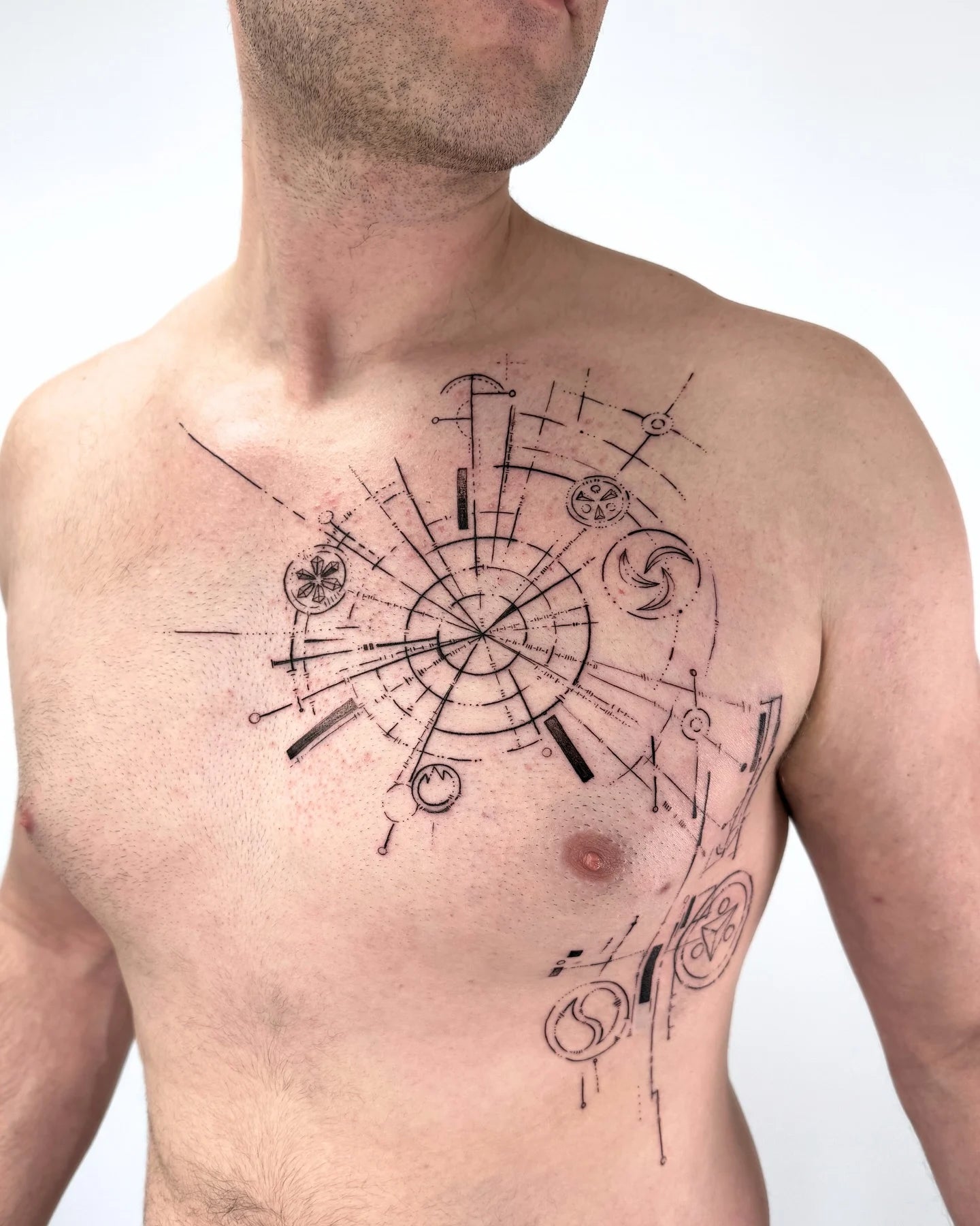 geometric man chest tattoo