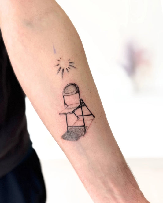 sun and chair forearm tattoo