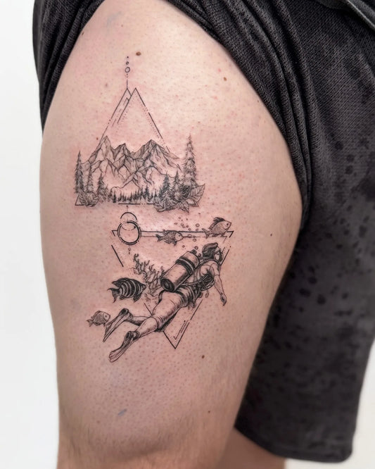 geometric diving and mountain scene thigh tattoo