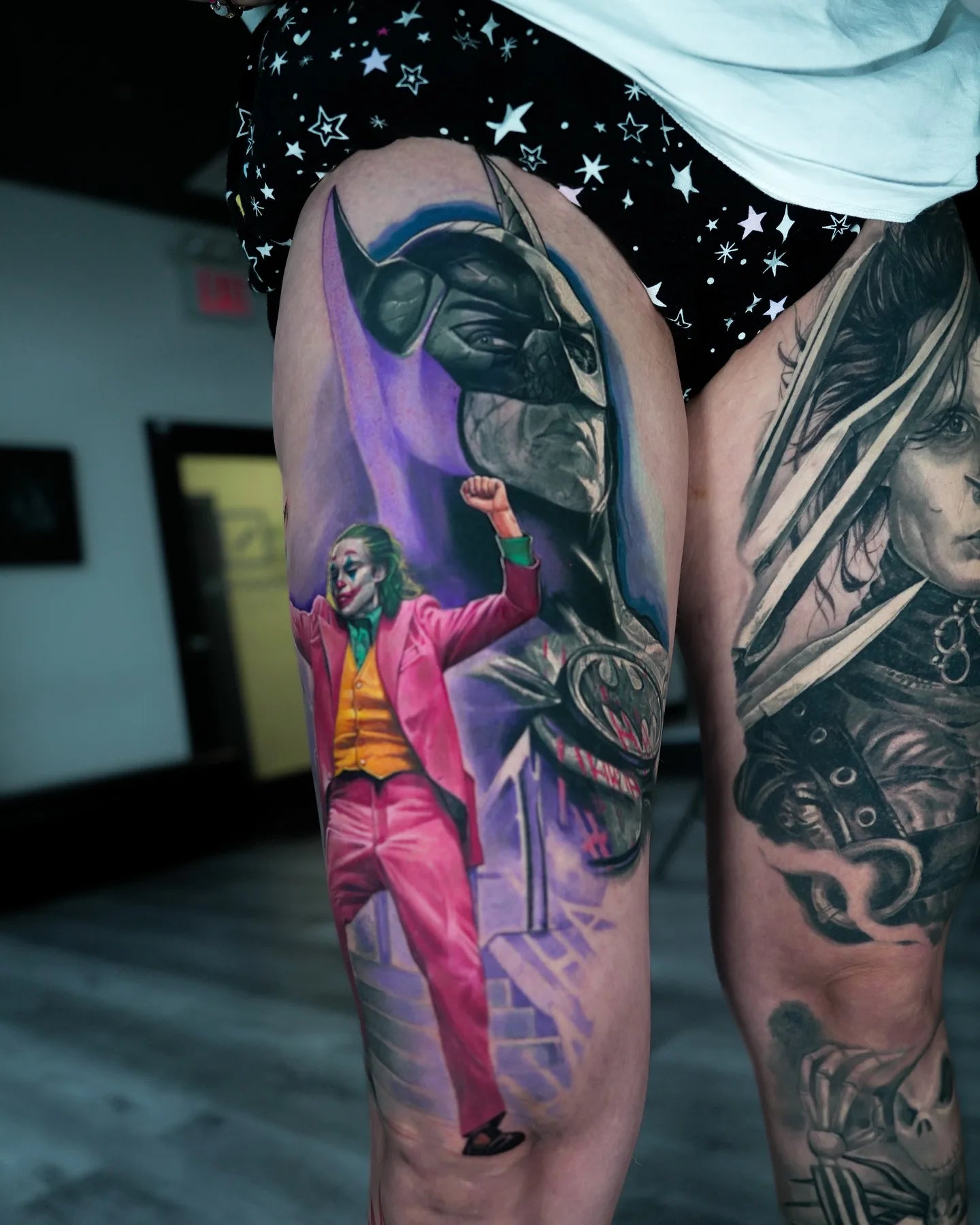 batman and joker color realism tattoo on thigh