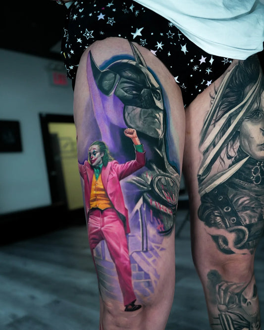batman and joker color realism tattoo on thigh
